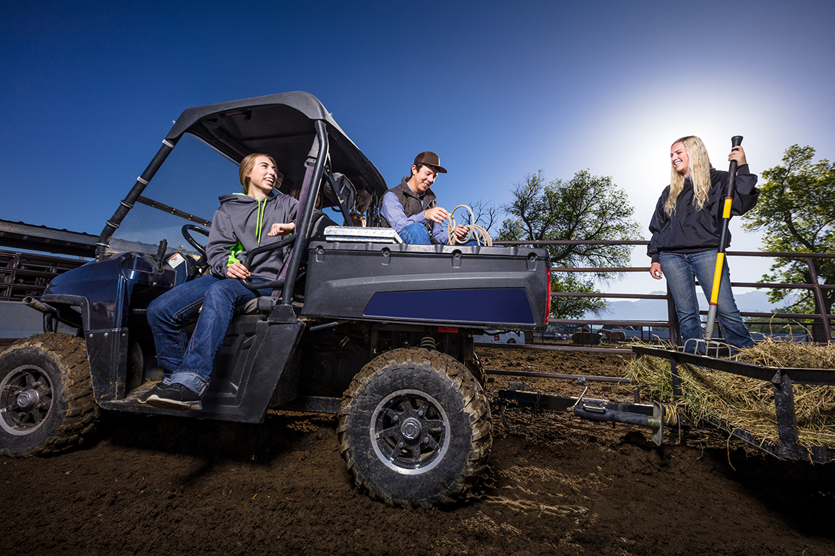 Three young people posing on UTV